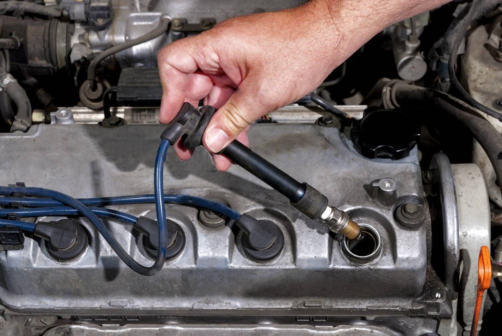 Spark plug shown beside a cylinder head